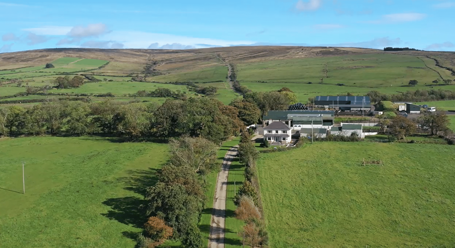 Drone image of Sheans Horse Farm framed by the green Antrim hills